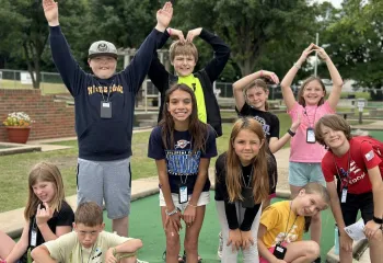 Kids in group making YMCA letters with arms