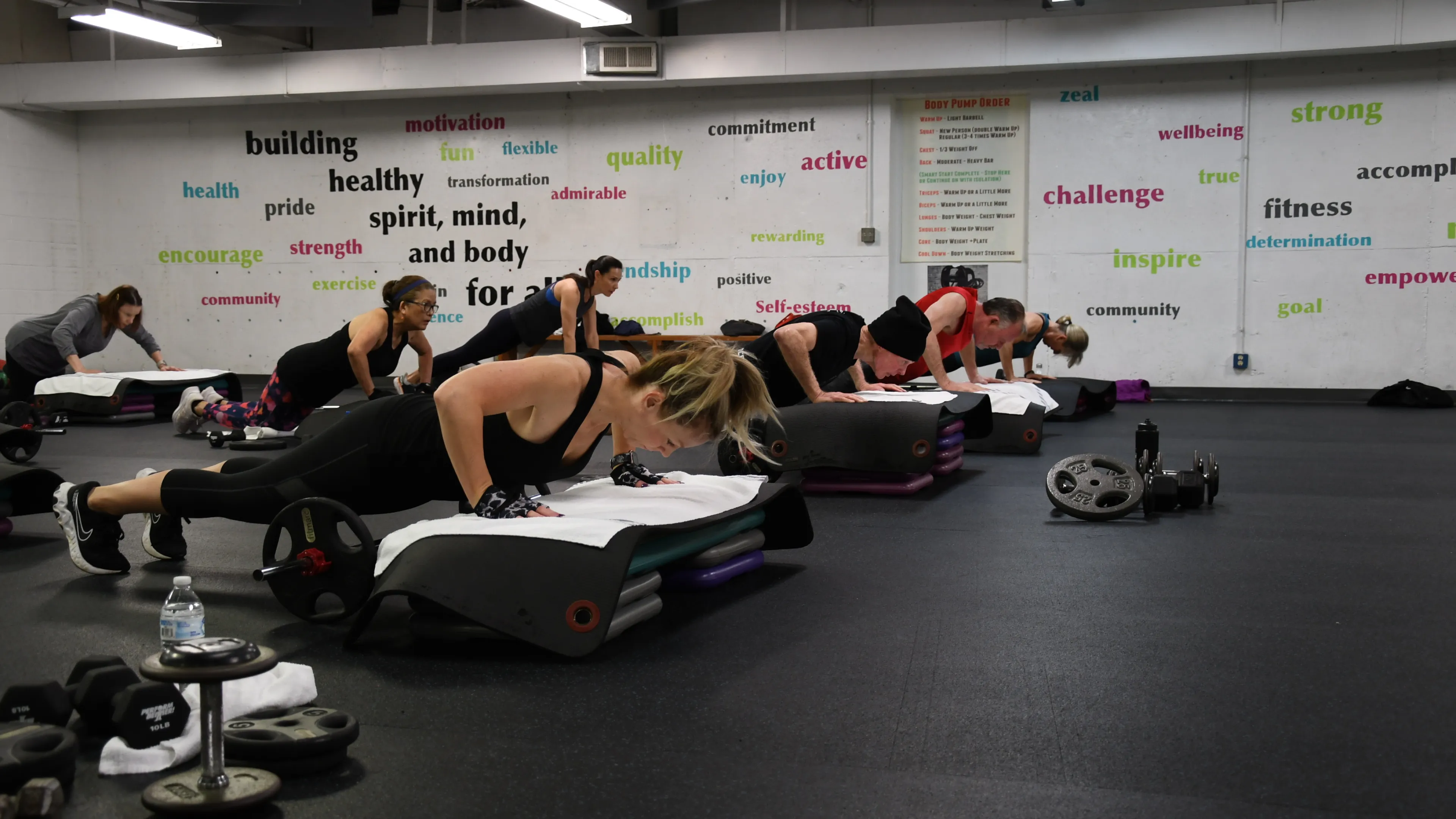 A group doing pushups on step risers