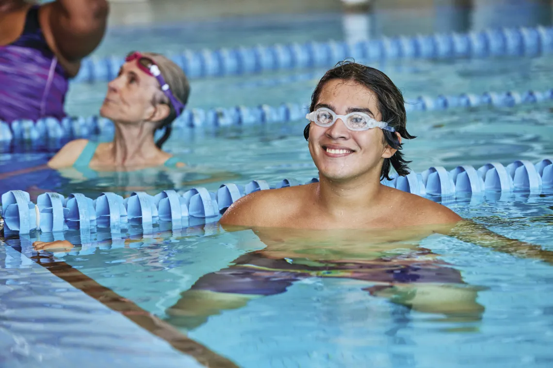 Adult Male wearing Googles floating in a pool swim lane