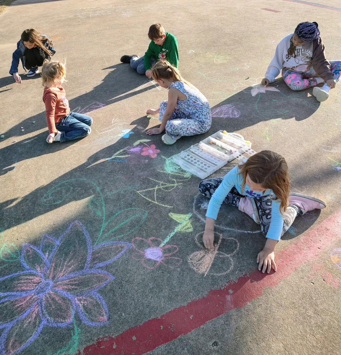 Students drawing with chalk