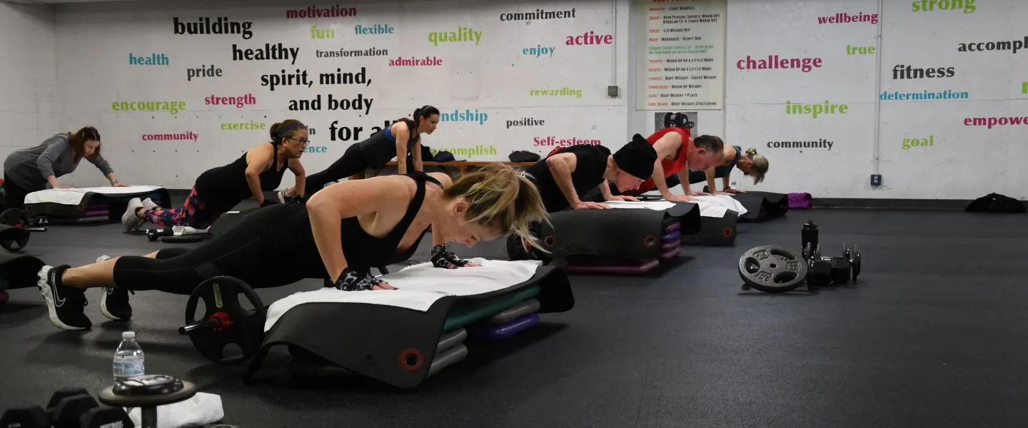 A group doing pushups on step risers