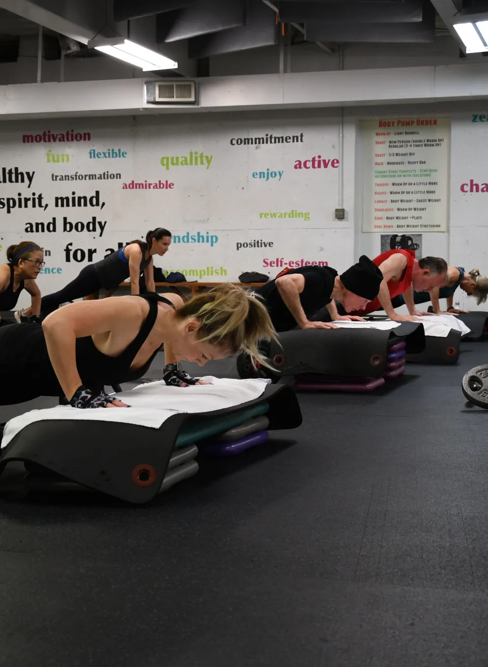 A group doing pushups on step risers